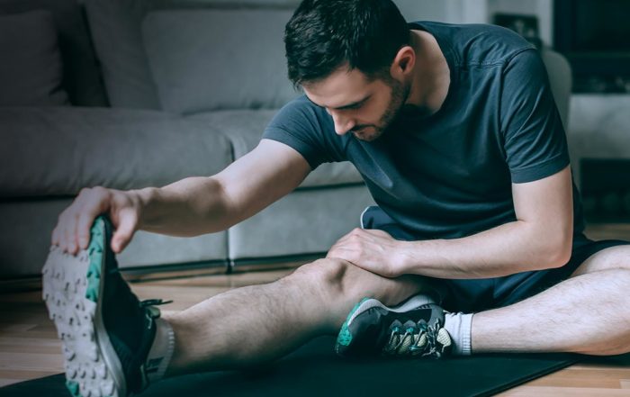 man stretching at home