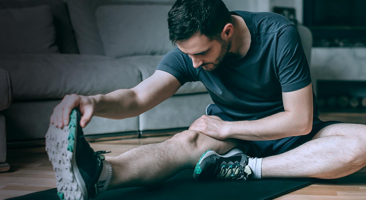 man stretching at home